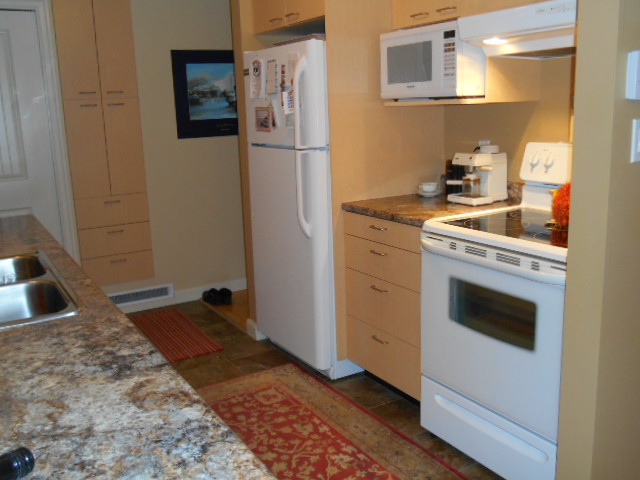 Kitchen: glass top stove, microwave, fridge, pantry Carriage House rental Mt. Tolmie Victoria